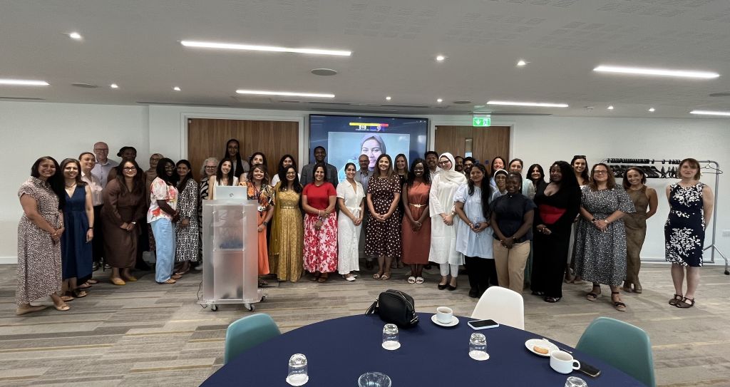 Wide group photo of multi-ethnic men and women celebrating South Asian History Month with the Royal College of Pharmacy