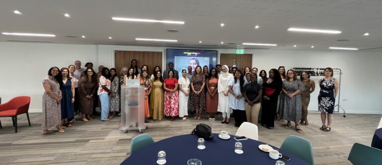 Wide group photo of multi-ethnic men and women celebrating South Asian History Month with the Royal College of Pharmacy
