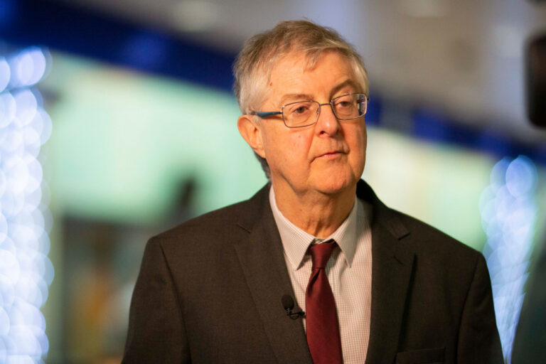 mark drakeford looking away from camera with blurred background