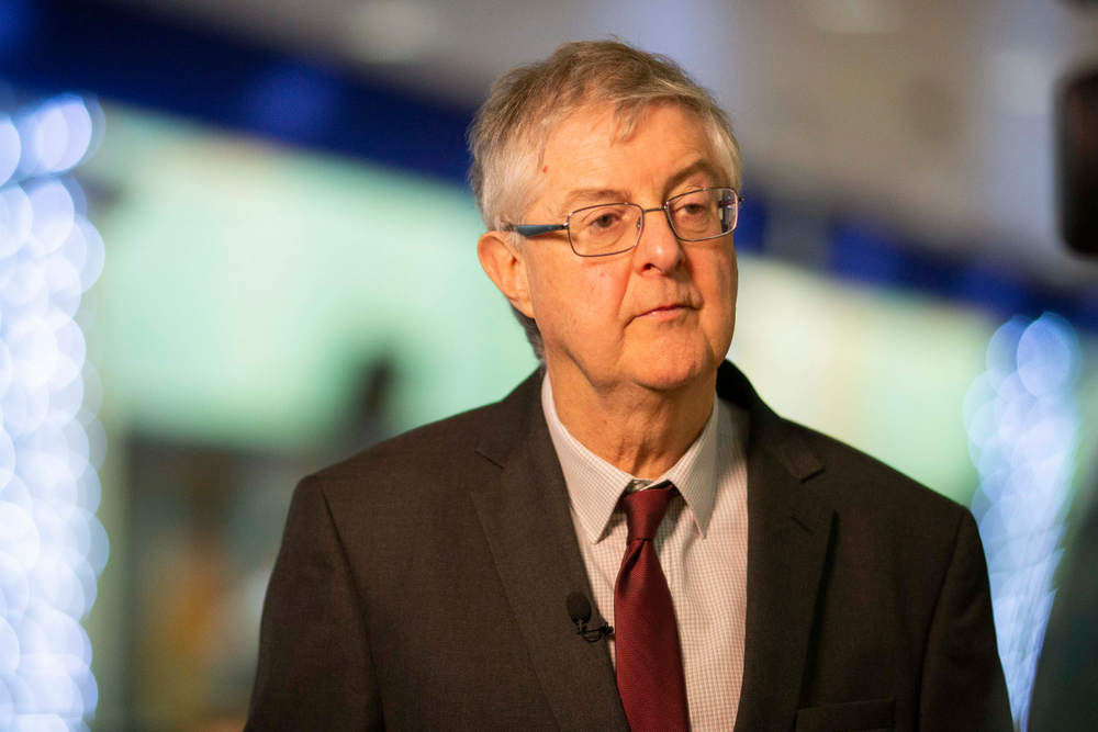mark drakeford looking away from camera with blurred background