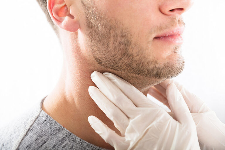 A healthcare professional checks a patient's lymph nodes