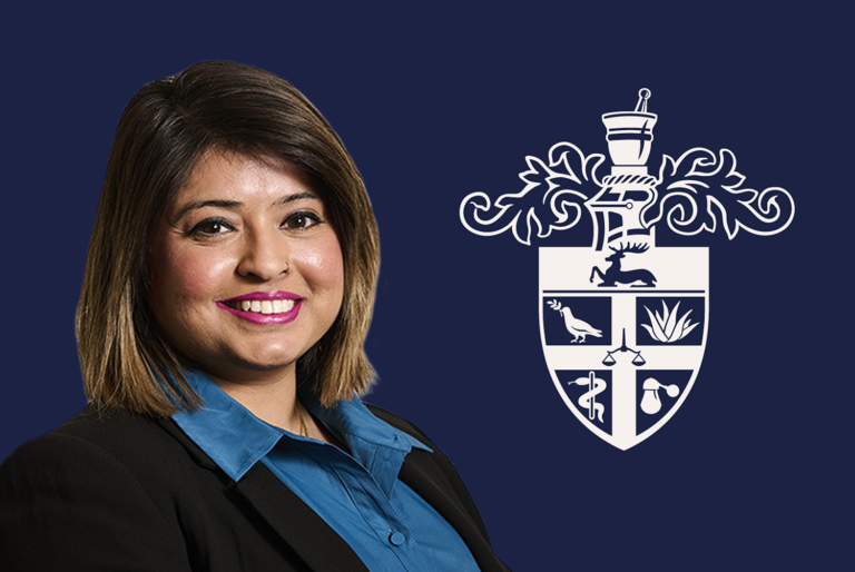 Amandeep smiles in front of a navy background and the RCPharm crest in white