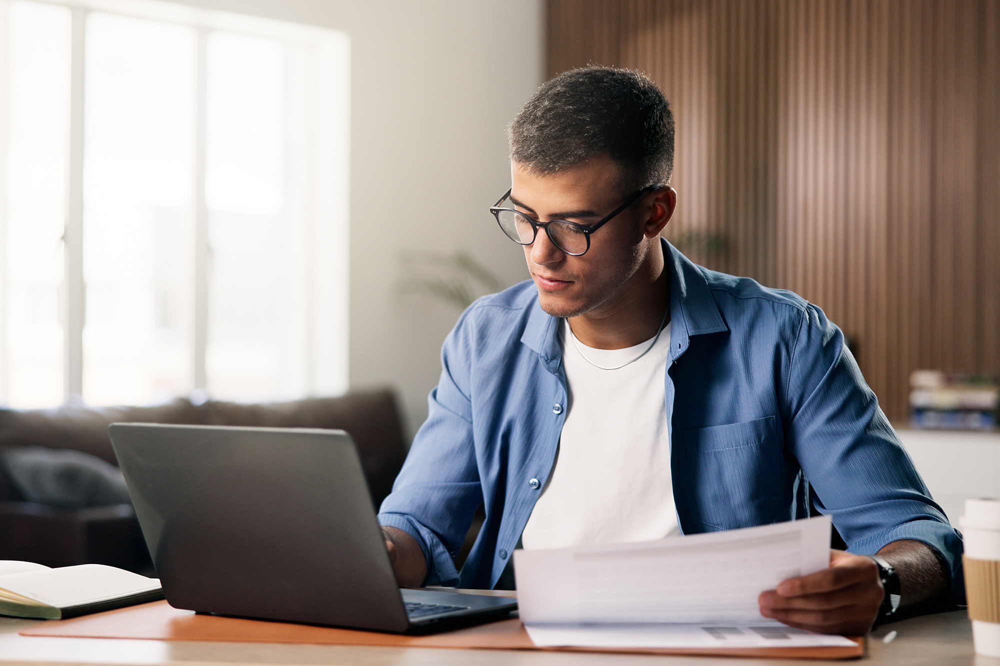 Documents, laptop and remote work with man in home study for planning