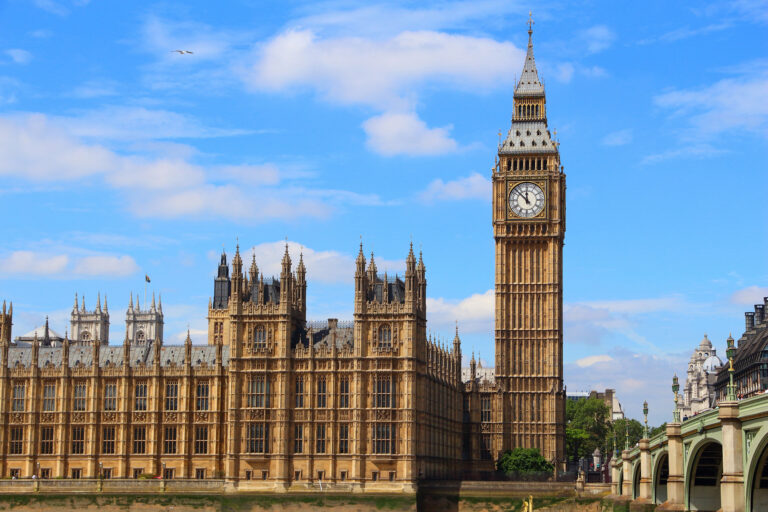 View of Westminster in London, UK from riverside. Blue sky and few clouds