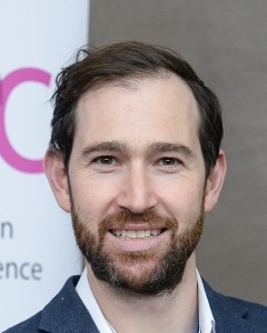 Head and shoulders image of Adam Turner, member of the ‘Pharmacy: Delivering a Healthier Wales’ delivery board, wearing a suit