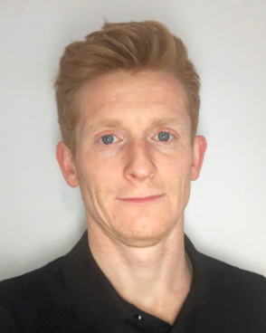 Head and shoulders image of Emyr Jones, member of the ‘Pharmacy: Delivering a Healthier Wales’ delivery board, wearing a black shirt