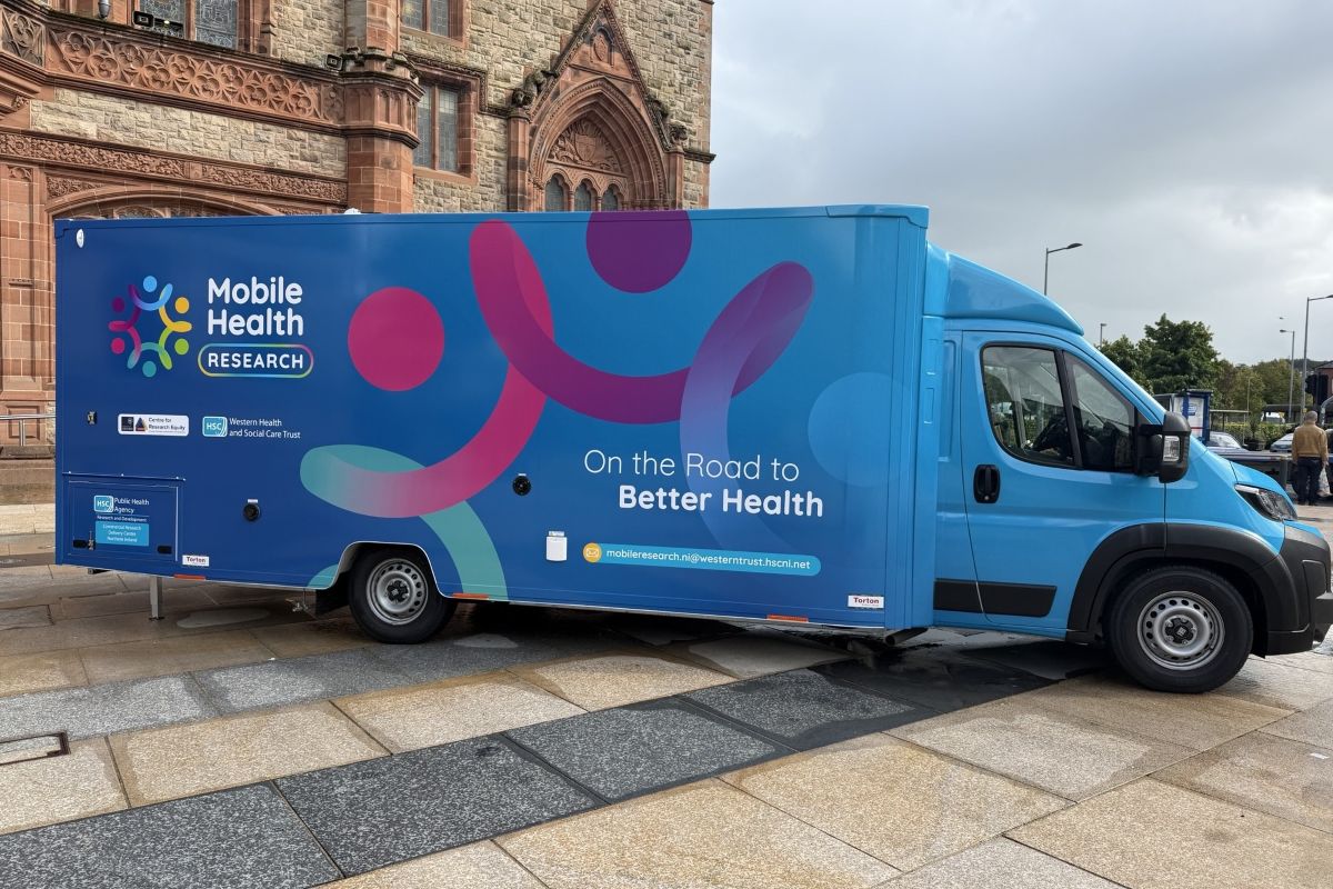 A blue mobile health van with the slogan 'on the road to better health'