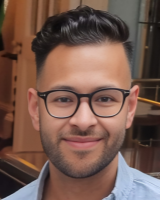 Head and shoulders image of Patrick Singh, member of the ‘Pharmacy: Delivering a Healthier Wales’ delivery board, wearing a grey shirt