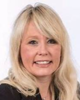 Head and shoulders image of Sam Fisher, member of the ‘Pharmacy: Delivering a Healthier Wales’ delivery board, wearing a black top