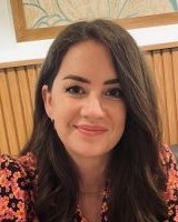 Head and shoulders image of Stephanie Hough, member of the ‘Pharmacy: Delivering a Healthier Wales’ delivery board, wearing a red and black top