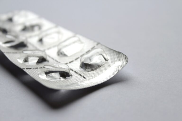 Empty plastic medication blister with no pills inside on white background.