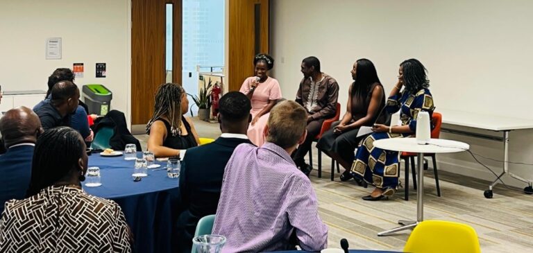 Tobi Oladejo, Sam Appiah-Anane and Jenny Ahua as a panel, sitting in a row of chairs addressing the event attendees